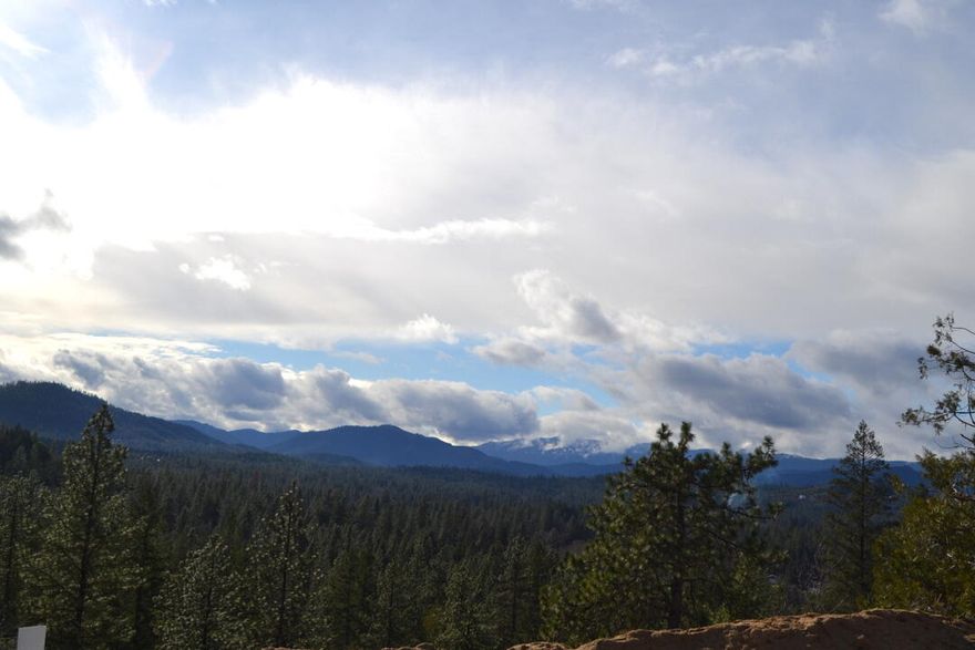 On a scale from 1 to 10 this is a 12! Very rare parcel on the edge of town! What is offered is exceptional acreage just outside the city and less than a mile to shopping and hospital/ medical. Great schools in District 7. The well is in and driveway and home pad too. This forested building spot is gently rolling to level with large conifer trees and lovely views on a quiet and secluded street. The neighborhood was just completed after years of work by the owners. Each home site includes broad band access, water, natural gas and much more. Choose your builder or we can recommend several. These are selling quickly as this is a rural subdivision of only 16 lots. Call for an information package. Better yet, come take a look. This is an amazing property to create your new custom home.