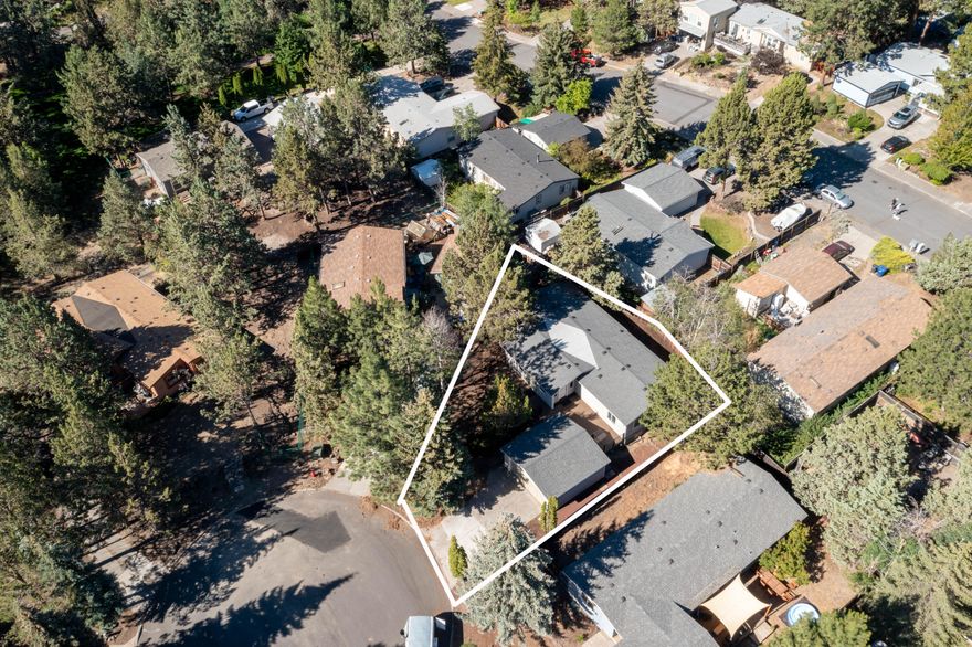 New flooring credit of $5,000 provided by the seller! Step into the past with fresh possibilities in this well-cared-for 1980 home that combines retro charm with modern comfort. Enjoy freshly painted interiors that brighten and refresh, along with a brand-new roof, all-new windows with coverings, and expansive front and back decks—offering peace of mind and inviting spaces indoors and out. With 1,598 sq ft, 3 bedrooms, and 2 baths, plus a detached 2-car garage, the home delivers comfort, flexibility, and style. Situated on a manageable 0.14-acre lot in the heart of Bend, it's ready to enjoy as-is or reimagine with your personal touch—an ideal opportunity to blend vintage character with contemporary living.