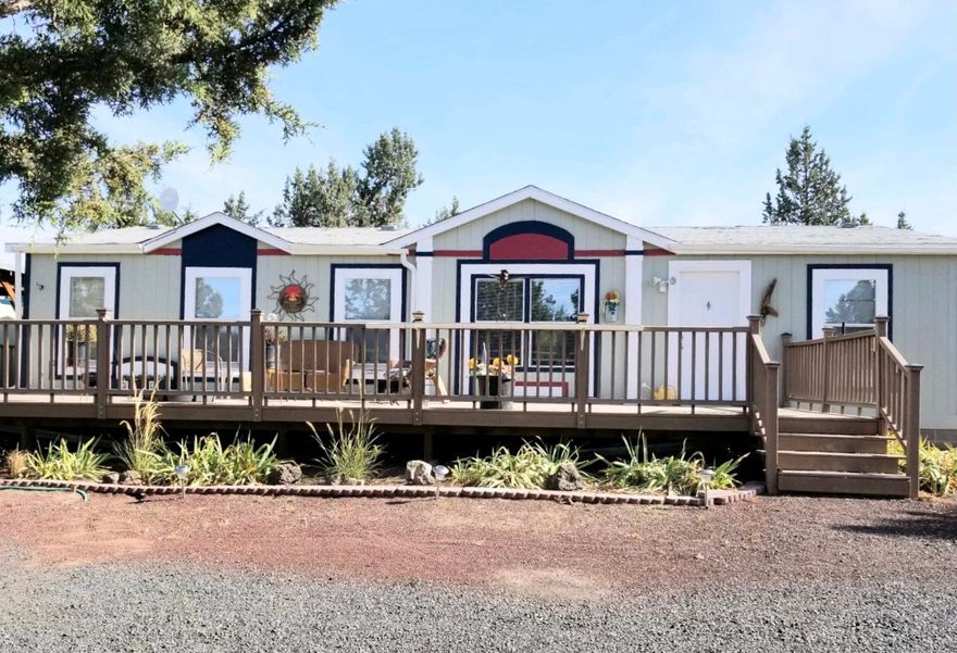 Beautifully detailed 1296 sq ft, 3 bed/2 bath home with wrap-around TREX deck and fully fenced 1.8 acre lot. Built in 2003 but looks and feels like new. Open floor plan with vaulted ceilings throughout. Large living room, master bedroom on separate end of house from 2nd & 3rd bedrooms. Pantry area in utility room, breakfast nook in kitchen, separate dining area. Carport with shop area. RV hookups. Landscaped garden areas featuring two 1000 year old juniper trees with plenty of room for barn/shop and animals. All appliances included.