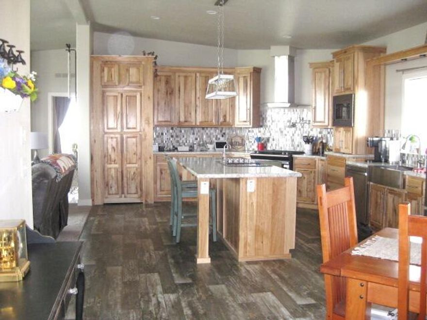 Spacious 4 bed/2bath  Home on near 20 acres for you to bring your toys, friends, and family to go to the dunes just down the road and have a great time while in the high desert. There's room for family with RV's too. Enjoy the many upgrades this home features from the approximate 9' raised-vaulted roof, making the open floor plan feel larger in the living area,  to the large island kitchen w/lots of hickory cabinets plus a hidden walk in pantry, gas stove w/water spout over the stove, or electric cooktop with downdraft vent.  Main suite separation featuring large bath with soaking tub, spa shower, dbl-vanity w/ lighted mirrors , open linen cabinet, walk in closet. Ceiling fans thrughout the home. Home has cement board siding and metal roof  and on a perimeter block foundation on top a full slab and seisemic straps in place to protect you from the elements. Home has a great water filtraton system too. To much to mention. Fenced back yard for your pets. Front and back lawn too.