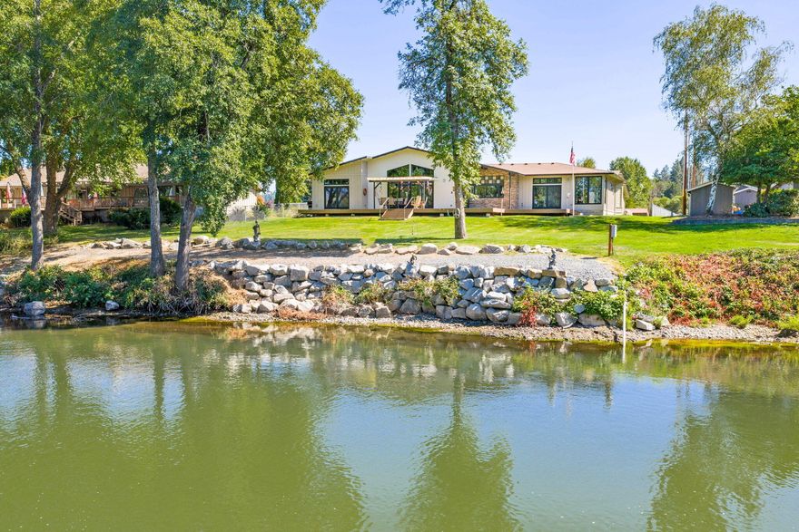 Timeless Northwest Elegance meets Quality Craftsmanship in this custom Gordon Longhurst-built home set on one of the finest stretches of the Rogue River. With sweeping river views from both suites and the main living area, this 4BD/3.5BA home offers refined comfort and exceptional design. The gourmet kitchen features granite counters, double ovens, a 5-burner gas cooktop, walk-in and butler's pantries, and panoramic river-facing windows. Enjoy 10-14' ceilings, solid doors, fine art niches, and Milgard ULTRA Low-E windows. Primary and Jr. Suites are thoughtfully placed in a split plan for privacy. The 4-car garage includes a workshop with 220 and gas heat. Spa-ready patio/courtyard, wine cellar, whole house zoned radiant heated floors, 2 HVAC systems and central vac are just a few wonderful features in this impeccably maintained home. A Video, a separate 360 Tour and a Comprehensive Feature/Good to Know List is available.  Just ask the Listing Agent!