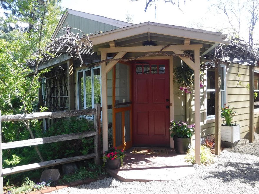 Tucked off the quiet street behind its own apple orchard, this bright, beautiful, and delightfully spacious four bedroom, 2.5 bath, single family home, sits in the middle of its own secret garden of mature trees, meandering stone walls, and artistic landscaping. Skylights and custom wood-clad windows bring in abundant light throughout all 2,650 square feet of indoor living space. Soak away the day's worries in the two-person jetted tub in the master bath, or cook up a storm in either of the two, well appointed, modern kitchens. Whether you intend to raise a family, create a mother-in-law suite, or turn the house into a duplex, this amazing home is a short walk to Ashland's famous downtown, hospital, schools, and shopping.