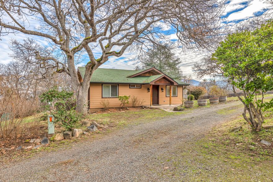 Enjoy Ashland living on a 2.46 acre horse property, just minutes from downtown. Owner will carry. The single-level farmhouse opens up to 3 bedrooms and 2 full bathrooms, with generous windows and exposed timber beams throughout. Underneath, there is a large 1,085' daylight basement with exterior access and a third full bathroom. Behind the home, you will find a 4-stall, 840' stable built in 2006, fully equipped with electricity. Use it for your horses or turn it into a shop! The property is fenced and irrigated with water rights from the TID directly behind the property, with a rear gate for easy access to the trails alongside it.