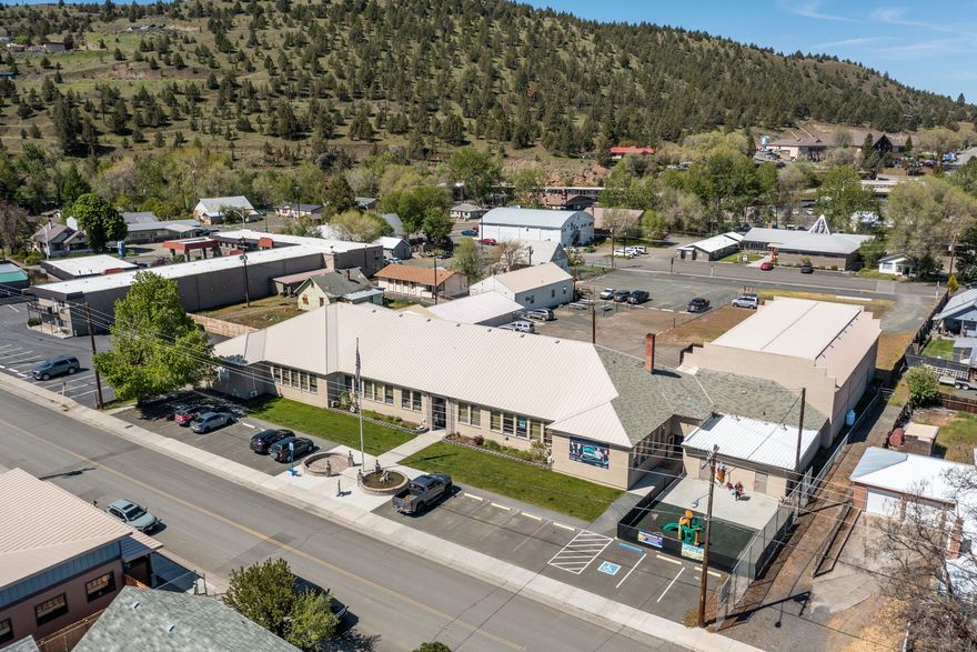 Do you have a call center that can be moved to rural USA? This could really help reduce your expenses and has income already in place.
Great Investment Property!!! This large commercial building has 13 offices spaces to lease out. Currently 10 are leased to tenants. Large gymnasium with 2 separate locker rooms, stage and fenced area outside for events. Property was updated with sheetrock, new flooring, LED lighting, fiber optics, mini splits for individual rooms, paved parking in front, lawn, landscaping, underground sprinklers, interior and exterior paint in 2015. Call Agents For Financial Documentation. Listing Agents are related to Sellers