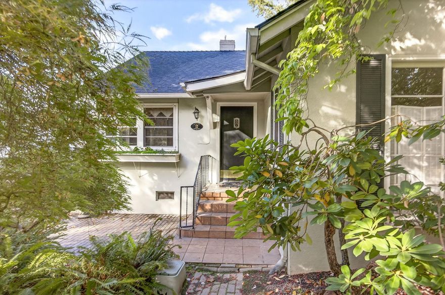 Nestled on the picturesque, tree-lined Glen Oak Ct in coveted Old East Medford, this lovingly maintained single-level home blends timeless charm w/ modern comfort. Gleaming hardwood floors flow throughout the living areas & all 3 bedrooms, creating an inviting atmosphere. The formal living room showcases a built-in fireplace and stunning floor-to-ceiling windows that frame views of the beautifully landscaped front yard. The spacious kitchen is a surprise—classic white tile counters pair perfectly with a newer stainless steel six-burner range/double oven & sleek range hood. Enjoy meals in the sunlit formal dining room, complete with a charming corner built-in. The cozy den opens through French doors to a serene side yard w/ a pergola, an ideal spot for morning coffee. Primary bedroom w/ dual closets and an adjacent full bathroom with a tub/shower combo. A full basement offers ample storage. Private backyard w/ mature landscaping and a detached single-car garage w/ room for a workshop.