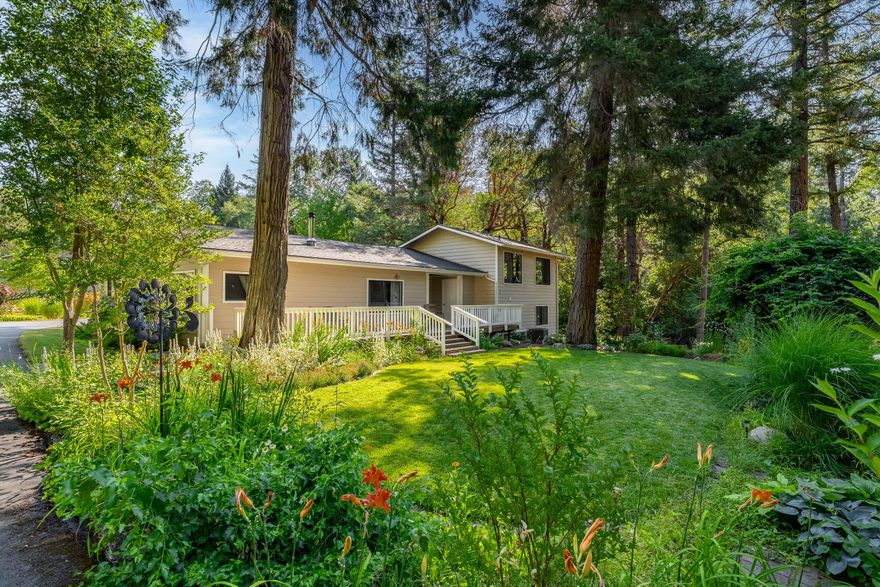 Experience peaceful rural living on 12+ beautiful acres of creek frontage. This inviting 3-bd, 2-ba home features a cozy living room with a woodstove and nice floorplan that flows into the dining room and kitchen. The primary suite is on the main level offering a tile shower, dbl vanity, water closet, and large walk-in closet. Spacious mudroom with tile & tons of storage. Upstairs is a bright family room wrapped in windows. Down a few steps are 2 more bedrooms & a fully updated bathroom. Outside, you'll enjoy multiple decks, fruit trees, large established garden and pasture for your animals. The refurbished barn offers endless possibilities—ideal for animals or extra storage. There is also a 1-car garage/shop. Whether you're dreaming of a small farm, a private retreat, or simply more space to breathe, this property offers it all. This is a rare opportunity to own a slice of paradise just minutes from town. Take a look today!