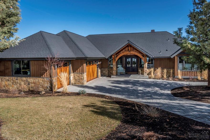 Gorgeous, one-of-a-kind Awbrey Butte like-new craftsman home w/Cascade Views. Modern, beamed great room w/FP. Glass door to covered deck w/fire pit veranda. Granite counters, custom mahogany cabinets/doors/trim, sub-zero fridge, Bosch app, dual sinks & island eating bar. Master suite on main, soaker tub & deluxe shower. Downstairs w/FP, kitchenette, office w/built-ins, movie theatre (4K projector/audio). Energy efficient w/radiant heat BR floors, AC. Natural design landscaping. Paver Drive. 3 car garage.