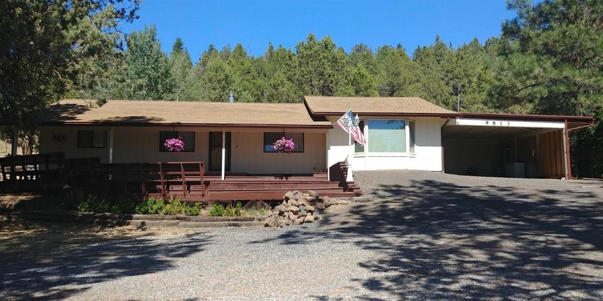 Owners have converted the family room into large master bedroom with 1/2 bath. Open kitchen /dining combo with dining opening to living room. Home features knotty pine interior, (seller has stated original oak flooring under laminate flooring) gas heat stove & ample storage throughout. Home sits on 1.72 acres with mature trees, large front deck that has built in benches , covered porch, 2 car carport, circular driveway, plus terraced decks in backyard. RV Parking w/electric and water.