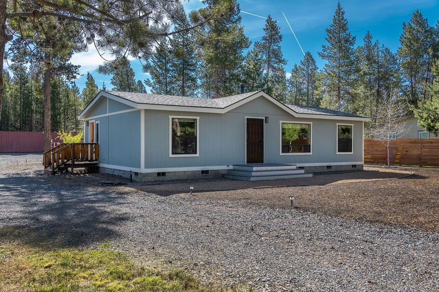 Refreshed and move-in ready oasis just one block from Big Deschutes River and National Forest access. Located in a sought-after community with a private marina, five deeded river easements, and high-quality community water. Recently renovated with a new roof, composite deck, xeriscaping, Milgard windows, full kitchen remodel, new appliances, water heater, flooring, interior/exterior paint, and custom floor-to-ceiling tile in baths. Fully fenced 0.52-acre lot with local timber, creating a peaceful, private sanctuary. Plenty of space for RV, boat, and trailer parking, plus a woodshed, carport, and 30-foot storage container. Impeccably maintained with detailed records. Surrounded by trails and wildlife, just a short drive to Sunriver and Mt. Bachelor resorts—ideal for full-time living or a weekend escape in Central Oregon's outdoor paradise.