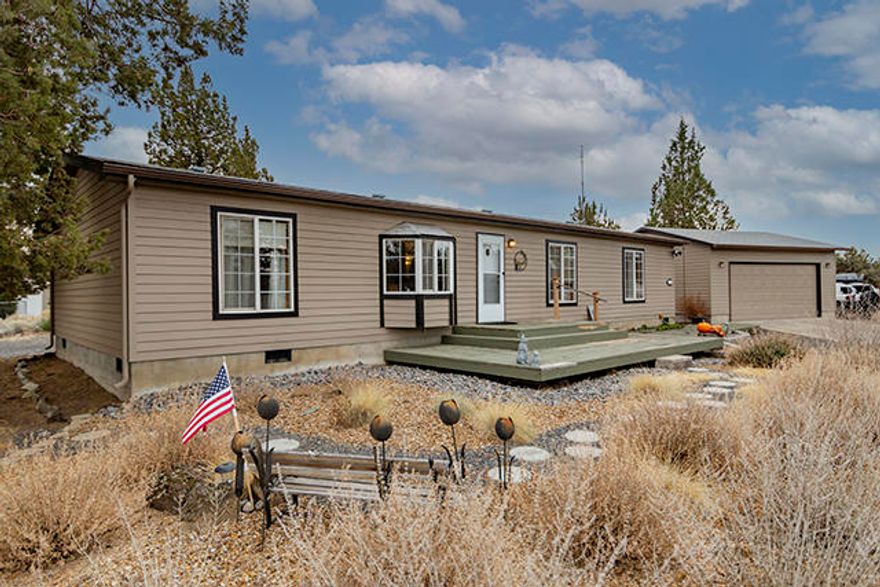 This charming 3 bedroom, 2 bathroom manufactured home sits on a quiet, level 2+ acre lot that backs to BLM land. It also has quick access to Hwy 97.  This well cared for home features a master bedroom with attached master bath.  The other two bedrooms are on the opposite side of the house, providing privacy.  The kitchen has a skylight that brings in natural lighting.  The vaulted living room is open to the dining room, which has access to the back deck and patio through a slider.  The laundry room is off the kitchen, and also has access to the back patio.  Outside, there is a detached 2 car garage, a nice matching shed with dog kennel, and plenty of parking space for your RV or toys!