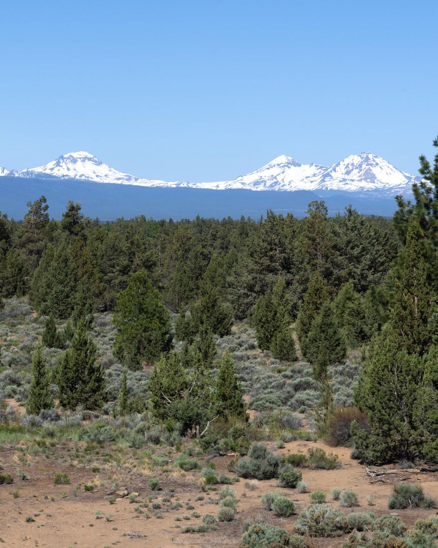 This property is truly exceptional & offers a unique experience. Ideal floor plan for multi generational living. Situated on 2.48 acres, the open vistas of the mountains create a sense of vastness & tranquility. Gourmet country kitchen boasts top-of-the-line Jennair appliances. Vaulted ceiling, skylights, & open floor plan connects dining area & great room making the kitchen the heart of the home. The picture window in the great room provides breathtaking views of the 3 Sisters : Faith, Hope, & Charity & Broken Top; perfect for gatherings with friends & family.Property features a fenced garden, providing a safe space to grow flowers & vegetables while keeping deer at bay. The 840 sq. ft. heated RV garage provides a secure & convenient place to store/maintain your RV. Landscaping of the property is meticulously designed & includes a sprinkler system. Neighborhood abuts BLM. The ideal retreat for those seeking a serene and picturesque lifestyle in close proximity to nature.