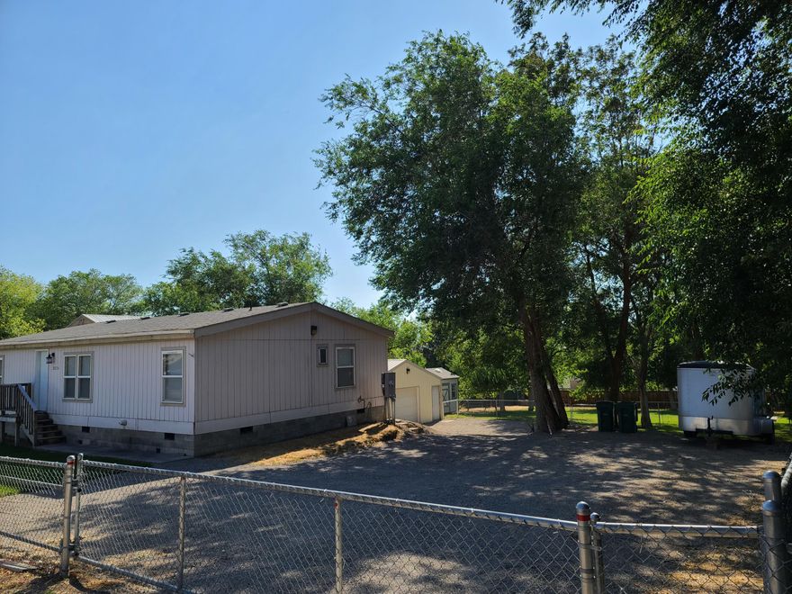 Come check out this super cute bungalow in a nice green park-like yard. This great 3 bedroom 2 bath home sits on just under a ½ acre that is a fully fenced and has a 24X24 shop and nice big shed. Enjoy the cozy covered deck in back or the nice big mature trees for extra shade by the fire pit. There is plenty of room for extra parking including RV and it has a RV power plug in also. This home is super clean and has all the needed updates along with newer appliances and carpet. You really need to see for yourself to appreciate.