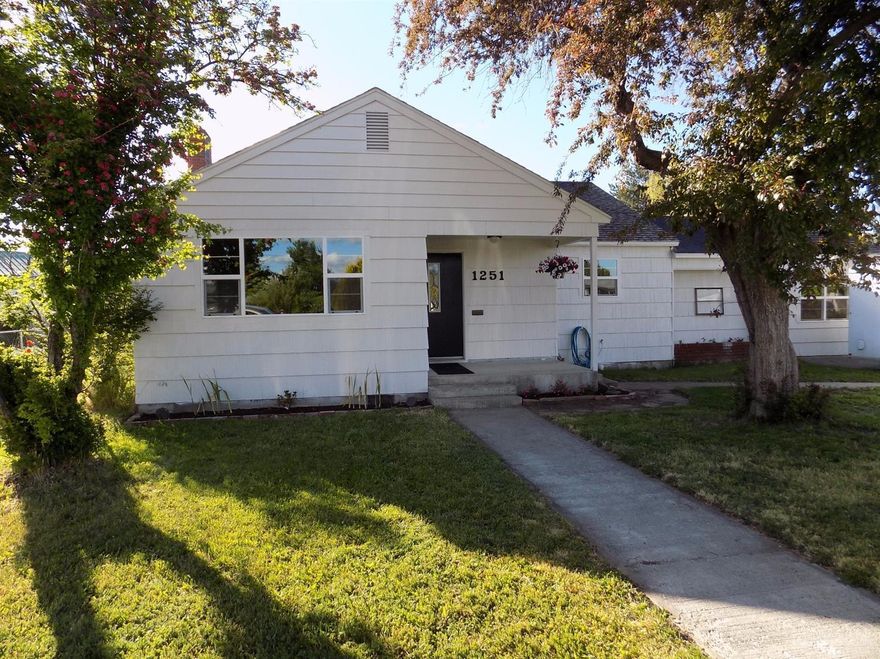 Nicely updated 4 bed 2 bath home in a great neighborhood! Freshly refinished hardwood floors throughout, tile in the kitchen and baths, granite counters, new windows and fresh paint! 24x30 shop in the back with alley access, fruits trees, heat pump with A/C! 1 year home warranty!