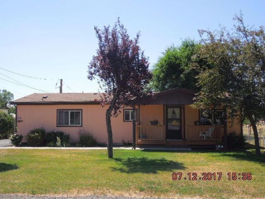 You will not want to pass up this cute manufactured home! Located on just shy of half acre and beautifully landscaped. Featuring 2 bedrooms, 2 bathrooms, vinyl windows, open floor plan with large living room and dining room. The laundry room / mud room leads back to the privacy fenced back yard, covered deck, and patio with dog kennel/garden area, and utility shed. Nicely paved driveway with gated access to the single car detached garage in the back. This home has been very well cared for and is in great condition.