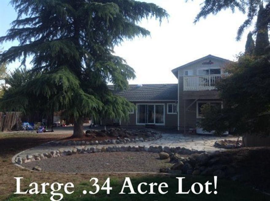 Spacious home on a large lot with spectacular views! 2247 Sq. Ft. 3 bedroom 2 bath with living room and separate family room with fireplace, great for entertaining! Eat-in kitchen with stainless steel appliances. Nice sized dining room with built-ins for extra storage. Master bedroom features on suite master bathroom and private deck with beautiful views. Nice sized guest bedrooms and guest bath with double sinks. Dream 18x32 foot shop with 220 power, just waiting for your hobbies/projects. Large fenced yard with amazing views, two carports, RV parking and much more. This is a must tour property!