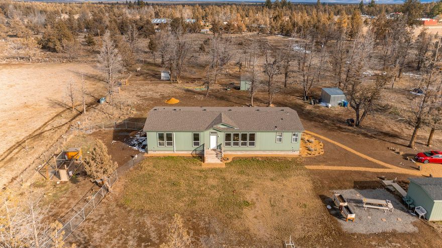 Just minutes outside of Bend sits a stunning piece of paradise. Your new home is situated perfectly to take in the breath-taking mountain views from the living room window. This charming residence offers the perfect blend of comfort and functionality with its 3-bedroom, 2-bathroom layout and inviting open floor plan. Enjoy year-round comfort with modern amenities including heating, air conditioning and Energy Star efficient features. The well-appointed Kitchen features knotty alder cabinets and a large island ideal for culinary adventures and gatherings. Indulge in the ultimate relaxation within the spacious master suit, thoughtfully situated on the opposite and of the house for optimal privacy. Turn on the ceiling fans located in every room with the windows open at night and listen to the peace and quiet of the country life style while cooling off the home. Plus, with just over 10 acres of water rights this property is the perfect fit for livestock as well. Oil pipe fencing lin