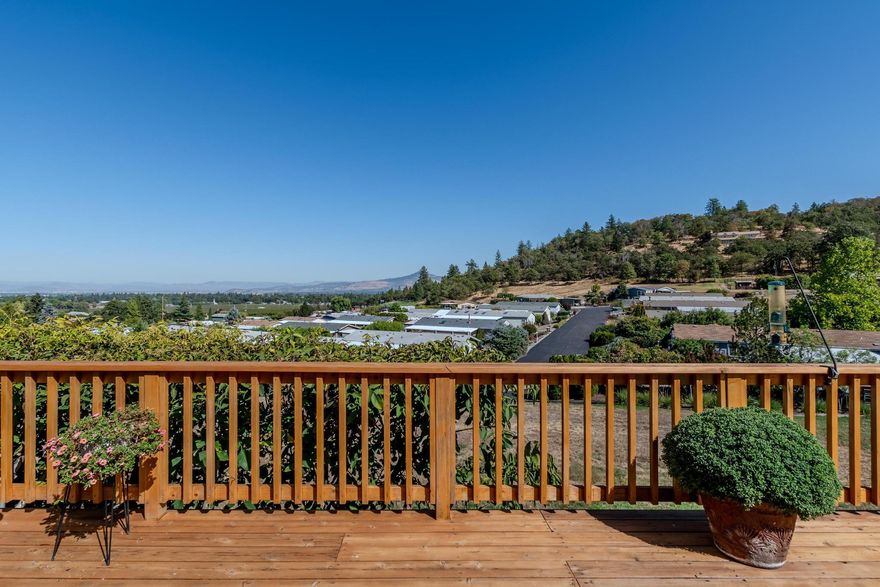 Well-maintained 1431 sq.ft. home with 2 bed, 2 bath + office in Western Carriage Estates, a 55+ community with a peaceful rural feel. Open floor plan with vaulted ceilings and a pellet stove with slate surround connects living and dining areas. The brand new wrap-around deck is a great spot to relax and take advantage of the sweeping Valley views. Spacious kitchen with skylights, laundry room with desk and storage cabinet. Situated on the top terrace of the park this is one of the few homes with such a setting. The fenced yard provides privacy and space for pets or gardening. Additional features include covered parking, a wheelchair lift, and convenient access to Jacksonville, Medford, and nearby vineyards. Newer roof and heat pump. Listing agents related to seller.