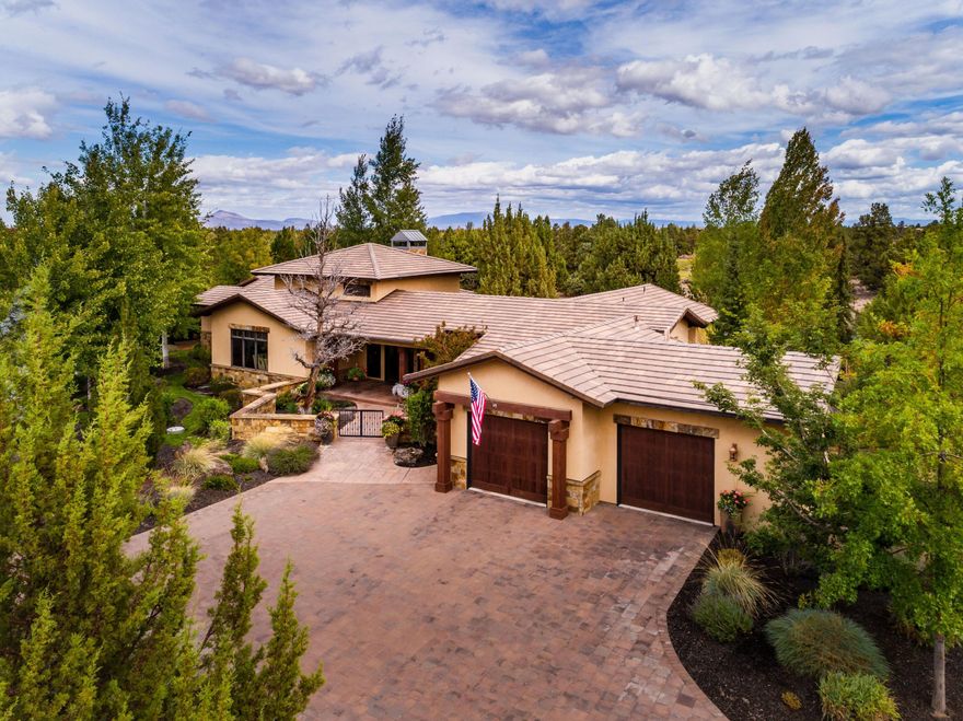 Experience privacy, tranquility and a stunning SINGLE LEVEL design located in The Estates at Juniper Preserve at Pronghorn Club, a premier golf community just 20 minutes from Downtown Bend. On a private .74 acre lot, this home offers an exceptional floorplan with natural elements, including exposed timber beams, stone, and copper accents. Great Room w/gas fireplace, soaring ceilings and separate bar. Chef's kitchen w/expansive island, SS appl, and butler's pantry. Formal Dining offers built-in wine room and Cascade Mt views. Primary Suite with gas fireplace, spa-like bath, soaking tub and tiled shower. 2nd Primary Suite w/sitting area/coffee bar and exquisite bath with sleek backsplash and tiled shower. 3rd suite is ideal guest/media room. Private home office. Enjoy entertaining al fresco on the covered back patio w/wood burning fireplace, outdoor kitchen, water feature, and hot tub. Impressive mudroom and oversized 2-car garage with dog wash/shower. Premier Pronghorn membership incl.