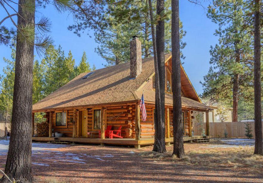 Attention investors! Whether you're looking for a serene getaway or an income-generating investment, this property has a proven track record as both a vacation home and short-term rental, delivering solid returns over the past 5 years.  Nestled among towering ponderosa pines on just over half an acre, this classic log home offers the perfect blend of rustic charm and modern updates. With 1,516 square feet of living space, this inviting retreat features two bedrooms, two baths, and soaring vaulted ceilings that enhance its open and airy feel. A striking stone fireplace serves as the heart of the home, creating a warm and welcoming ambiance. Thoughtfully remodeled, the home boasts slate flooring, stone countertops, and several newer appliances, combining timeless character with contemporary comforts. Step outside to enjoy the fresh mountain air from the private hot tub or make use of the convenient storage sheds.  Experience the beauty and tranquility of this beautiful log home retreat!