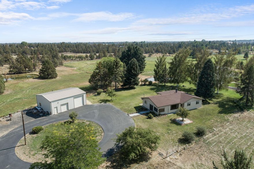 Are your looking for a potential family compound or the ability to develop a couple lots?  This is zoned SR2-1/2 which means could possibly be subdivided into 3 or 4 lots. This property features 11.36 acres with 7 acres of COI irrigation, fenced and cross fenced.  32 x 40 insulated shop with 12 ft doors and wood stove. Nice single level home features 3 bedrooms and 2 baths, sunroom, large laundry room, spacious kitchen has been updated with Corian countertops, eat in area as well as a formal dining room.  Nice sized living room with large picture window to take in the Cascade Mountain Views. Covered back deck perfect for relaxing.  Detached 2 car garage with separate work shop area.   Barn  and chicken coop. Perfect for your animals.  This property has been well maintained and cared for.  Buyer to do due diligence regarding dividing of land. Close to Pine Nursery, Airport, Hospital, Schools and Shopping.  Must see!