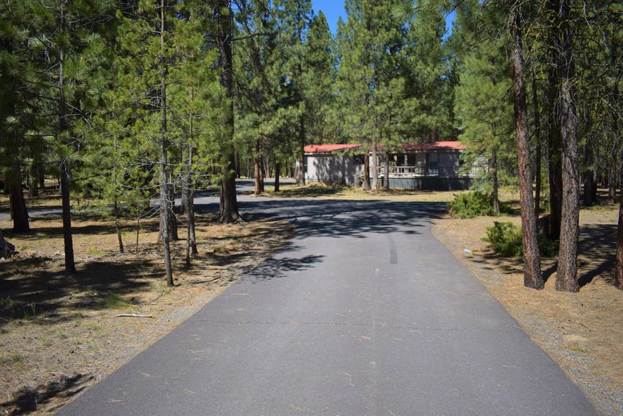 Looking for a great home located in the desired Ponderosa Pines? Looking for space to roam? This could be the home and property for you! Beautiful Asphalt circular driveway, with a home that sits back on the lot for added privacy. This property offers a 3 bedroom 2 bath home 1620 sq feet located on an acre and a half + or - ! This home has an open floor plan offers plenty of living space!  Clean and ready for a new buyer. The property has  plenty of room to build garage/shop.   Sale includes a certified wood stove for those chilly nights.  Amazing lakes, rivers, camping, hiking, biking, fishing, an excellent area for recreation! Located just south of Sunriver and Bend! Come get some R & R, and live or vacation amongst the big ponderosa pines! Great vacation home or primary residence!
