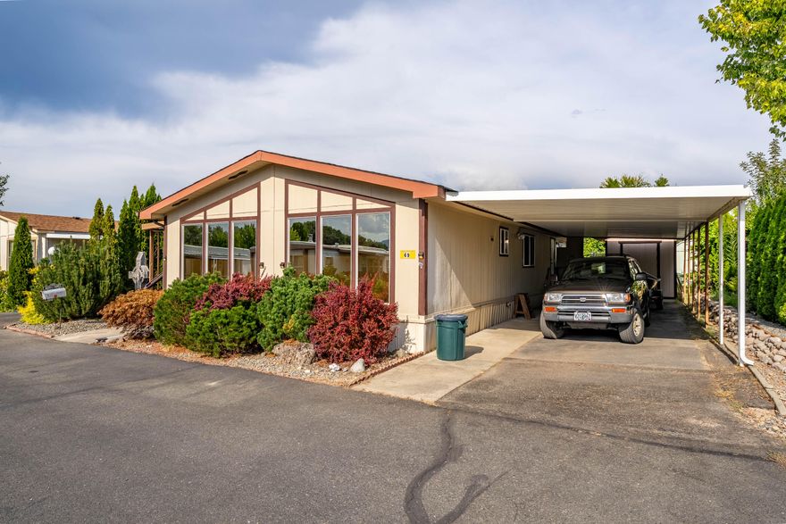 MOTIVATED SELLER. PRICED TO SELL. Beautifully maintained 2-bedroom, 2-full bath, in-park MH in the highly sought after 55+ Riviera Mobile Park a Resident Owned Community. Walk/bike path, picnic tables & Rogue River frontage available for residents use to fish, walk or just enjoy! The large covered porch offers plenty of room for al-fresco dining or entertaining. Elevated ceilings & large view windows create a light & bright home. Formal dining room could be crafts area or office. Beautiful tile & glass pass-through doors enhance the primary bath, with matching tile continued in the hall bath. Laminate flooring and neutral tones extend a sense of relaxation & easy care. Low water landscape enhance privacy and cool shade. HVAC heat-pump system installed 2017 by GP Heating & Air. The covered, attached carport has room for your car and boat. Park club house & activities to extend conviviality. Minutes from Grants Pass and all it has to offer. Don't miss seeing this wonderful home.