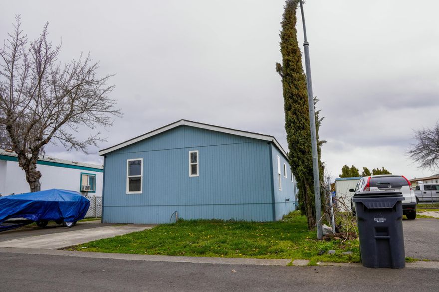 OWNER CARRY AVAILABLE!! Opportunity knocks! This 3-bedroom, 2-bath home offers 1,344 square feet of potential, ready for your vision and personal touch. Whether you're an investor or a buyer looking to build equity, this property is a true fixer with solid bones and tons of upside. The layout is spacious and functional, featuring a large living area, indoor laundry, and a generous kitchen that comes complete with all appliances. Outside, you'll find covered parking for two vehicles and a storage shed for added convenience. Located in an all-ages community park. Bring your toolbox and imagination—this is a chance you don't want to miss!