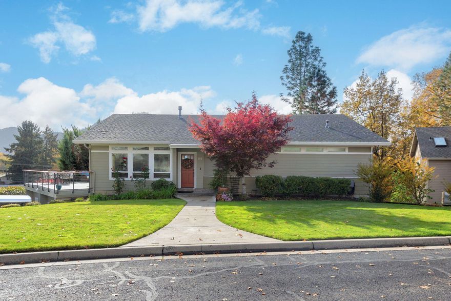 This stunning 3 bed, 2.5 bath home offers a fantastic floor plan, custom finishes throughout, and breathtaking mountain views. Situated on a desirable corner lot in a wonderful neighborhood, you will be close to downtown Rogue River, just minutes from i5, and perfectly positioned between Medford and Grants Pass. Step inside to find 2,712 square feet of classic features, including beautifully maintained engineered hardwood flooring. The main living room features vaulted ceilings and a cozy gas fireplace, while the spacious kitchen opens to a dining area and a newer deck- perfect for enjoying those spectacular views. Downstairs, a bonus family room and newer patio create ideal spaces for entertaining guests or relaxing with family. Additional highlights include an oversized garage with ample storage, a bonus pantry, and thoughtful updates throughout. This home truly has it all- comfort, style, and location offering small town charm with easy access to everything you need!