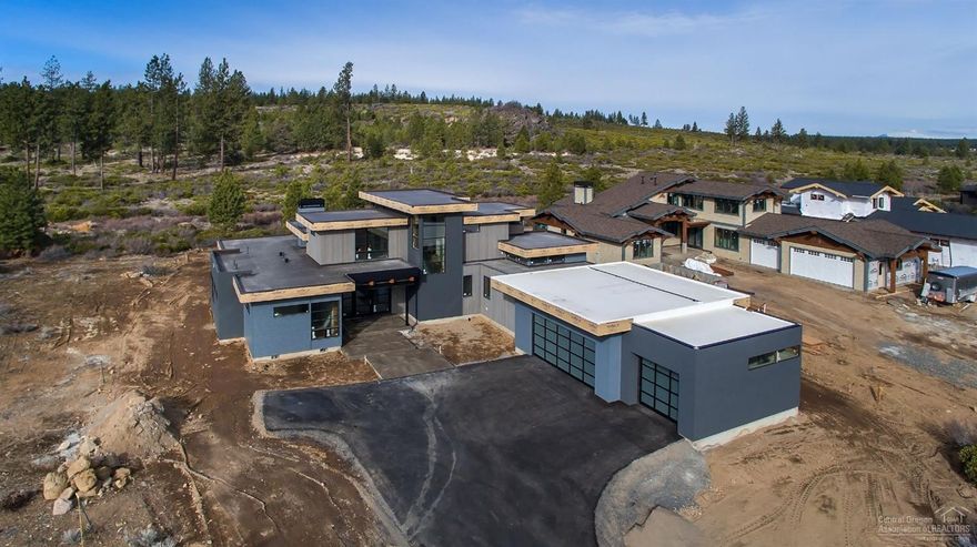 Bend Trend Homes has completed another stunning home that is nothing short of exceptional in quality and design. Bike Phil's Trail out the back and play golf out the front of this NW contemporary Tetherow home. The .5 acre lot backs to National Forest ensuring protected views and privacy. The design boasts a chef's kitchen, two main level masters, wood-covered ceilings in Great room, bonus, office, 3-car garage, an incredible window design and two slider walls opening to private exterior living space.