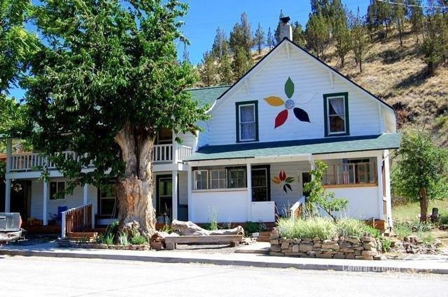 Amazing renovation of this historic home/duplex in downtown Mitchell, formerly known as Sally Weinbarger's. Great potential for this home/duplex or Bed and Breakfast on almost half acre. Most of the work has been done including 5 bedrooms, 2 baths, 2600 sq.ft. built in 1900's. added charm with The hole in the wall storage building plus Tessla station for electric cars. Updates include new foundation, roof, windows, septic, hot water heaters, newer wood stove and more. Partially furnished, all appliances included. Landscaped with several fruit trees in backyard area. You will love the covered front decks to enjoy the morning sun plus upstairs patio on east side, over look tiger town stage and street side area protected by large cherry and cottonwood trees.