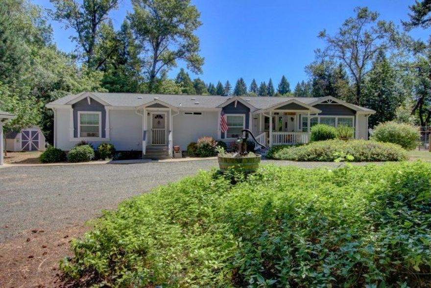 Stunning is the best way to describe this incredible Home. Situated on 4.5 acres with a year round creek in the back of the property. Pasture is below the house level and is very secluded. It is also situated on an Aquafer and is green year round. Great Well that is spring fed. The Fleetwood Barrington is 2693 sf with 2 x 6 interior walls. It has a very open and flowing floor plan with extra large halls and plenty of storage. The kitchen has solid alder wood cabinets and is a cooker delight and great for entertaining. Living room has a real wood fireplace and sits just off the kitchen. Windows throughout brighten the home as if it were in a magazine. The master bedroom is incredibly large and has a big walk-in closet, a master bathroom sure to please, and an office sits off the this same bedroom. 4-car insulated and finished garage, 1120sq.ft. Provides plenty of parking and also a great work area sure to please any hobbiest. There is a lot a covered RV or Boat carport to the s