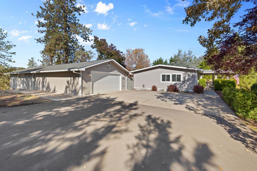 Come discover this unique home on 1.88 acres in a rural, serene setting. The property provides ample space for privacy and outdoor activities, including a detached garage with an extra room and workshop. The home has been completely updated, including the addition of a beautiful sunroom (included in the sq ft). Gourmet kitchen with granite counters, tile back splash, tons of storage, and all the appliances, including a double oven. Large primary bedroom. The primary bathroom has a walk-in stone and tile shower and double sink vanity. Two guest bedrooms and guest bathroom. Interior laundry room includes a washer and dryer. The detached garage has an extra room and a large workshop. The backyard is perfect for entertaining or just relaxing under the covered patio.  Its location combines the tranquility of country living with convenient access to the nearby city's amenities, making it a perfect blend of peaceful and practical living. Come tour this one of a kind property.