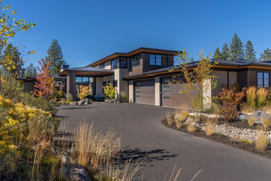 From the moment you enter this stunning contemporary home you'll feel a sense of serenity, enhanced by the floor-to-ceiling windows framing unobstructed views of the Deschutes National Forest. Enjoy luxurious finishes like honed quartzite countertops and oil-finished white oak and Italian porcelain floors. Chefs will love the thoughtfully designed kitchen w/ oversized island, spacious butler's pantry, & Thermador applcs. This home features 3 BD + bonus room up & 2 full suites on the main level, including a spacious owner's suite tucked into the back corner, offering patio access, spa-like bath, & w/i closet. Wine-lovers will appreciate the temp-controlled custom wine cellar w/ room for nearly 700 bottles. The 4-car garage offers a shop area, epoxy floors, storage, & dog wash. Outside, entertain on the well-appointed patio, featuring heaters, firepit, hot tub, & two built-in grills. Access forest trails from your backyard, or enjoy the amenities of Tetherow Resort just up the street.