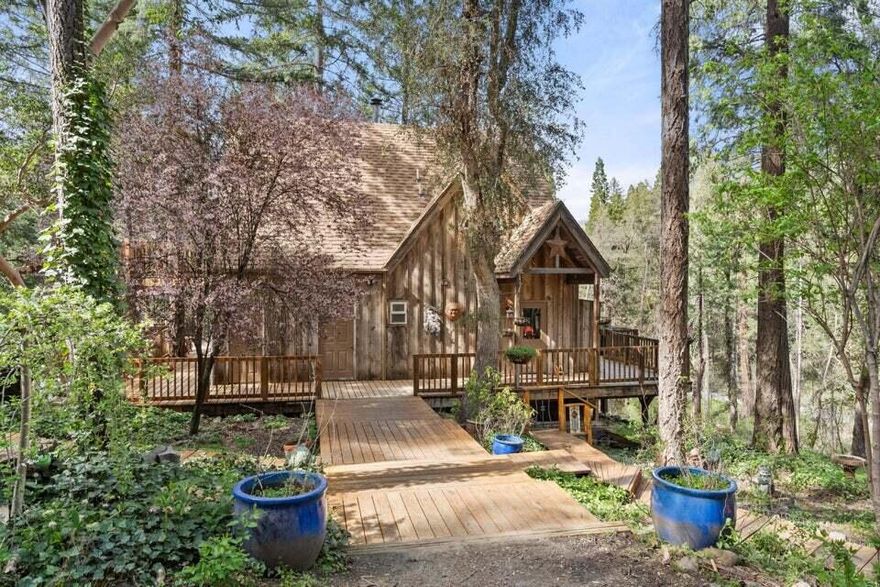 Location, location, location! If you're wanting to get lost in the woods in a cozy property, this is the one for you! This two story charmer features 2 bedrooms, 2 bathroom, 1736 sq ft, 3.63 acres, wrap-around deck (2,500 sq ft of decking), hardwood flooring on the main level w/ pine flooring upstairs, main level bedroom, 2 wood burning fireplaces, vaulted ceilings, spacious kitchen (granite countertops, island, ample cabinetry), open floor plan, 2 detached garages w/ additional shop space above (currently used as an art studio and for storage), gated entryway, raised garden beds, creek frontage, & much more! BLM & ATV trails are nearby as well! Perfect opportunity for anyone that is looking for tranquility and to get in touch with nature! This one won't last long on the market, so contact your agent today for a personal tour, before it's too late!