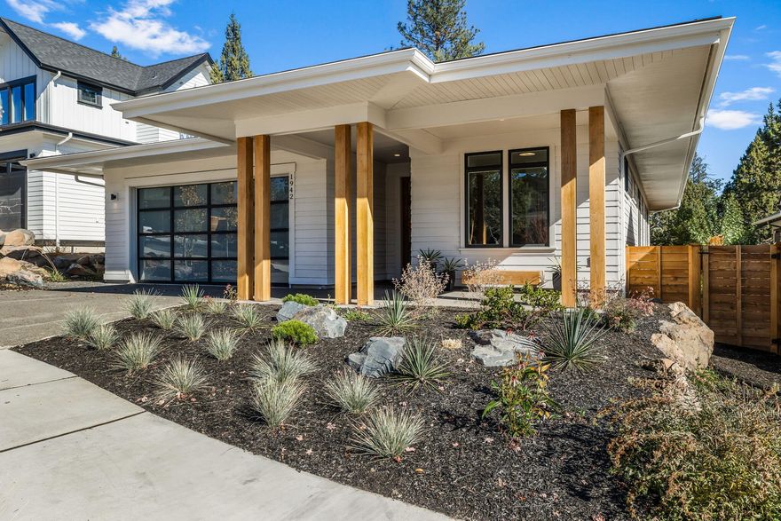 Enjoy all that NorthWest Crossing has to offer from this better than new single-level home! Completed in 2022 by Curtis Homes, the clean lines of Prairie-style architecture exemplify the meaning of curb appeal. Thoughtful upgrades include enlarged windows that illuminate the Scandi-modern interior while hardwood floors grace nearly every room. A floor to ceiling chiseled stone fireplace anchors the impressive great room while the stunning showcase kitchen is equipped with rift oak cabinetry & large island with waterfall edge. The primary suite evokes spa-like serenity in the luxurious bathroom adorned with a freestanding tub, curbless shower, & floating double vanity. Whether conversing with neighbors from the covered front porch or enjoying moments alfresco on the rear hardwood deck, the line between indoor/outdoor living is blurred. An exceptional neighborhood location puts Discovery Park, trail access, The Grove Market Hall, and more at your doorstep! Celebrate the good life here!