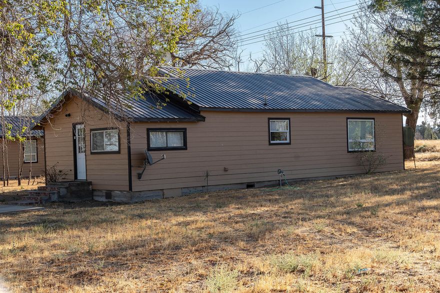 This country property consists of 64.51 ac with 56.8 ac COID water rights and two dwellings.  The 1,275 sf main home is 2 bed 1 bath.  The interior has been recently remodeled inside and exterior painted with a newer metal roof.  Small 12 x 18 paver patio.  The second dwelling interior has been recently remodeled inside and exterior painted with a newer metal roof.  This has a 12 x 18 deck off the front.  This very cute 640 sf cottage could be used for guests or multigenerational living.  Older deciduous and pine trees provide excellent shade.  Avion Water supplies domestic water.  Cascade Mountain views from most of the property.  Property borders the large COID irrigation canal on west side of the property.  This property is fenced and cross fenced.  Outbuildings include a 12 x 40 storage shed/shop and a 30 x 40 rock storage building (original home).  All outbuildings have newer metal roofs.  Possible replacement dwelling with beautiful Cascade Mountain views/ irrigation canal.