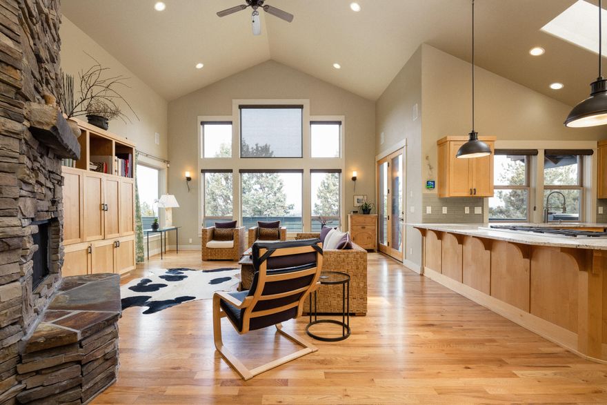 This warm and inviting custom home on Awbrey Butte showcases morning sunrises and twinkling city lights at night. The great room is light and bright with vaulted ceilings, full stacked stone fireplace, upgraded kitchen with granite counter tops and 6 burner range, solid wood doors, and beautiful hardwood floors.   The primary suite is on the main level with vaulted ceilings, sliding glass door to the deck, large walk-in closet with built ins, travertine shower, double sinks, and jetted tub.  The 2 bedrooms upstairs are vaulted with spacious walk-in closets and an additional loft area/flex space. The third bay of the 1105 SF garage was converted to a workshop with an additional 200 amps of power for tools.   The driveway is heated, solar panels save about $40/month from the power bill, & there is a large dry area under the home for storage or potential to remodel into additional living space.  This is an exceptional value for Bend's west side.
