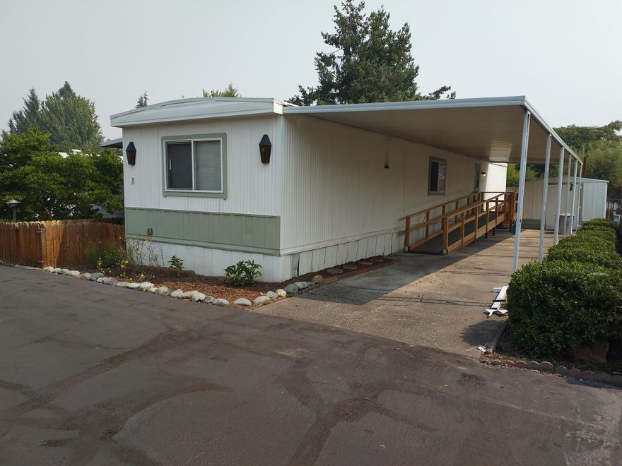 Here is your chance to own in southern Oregon! This home had a new roof and double paned windows installed in 2010 and carpets in 2015. Features include a separate dining room, lots of cabinet space in the kitchen, and a slab cultured marble shower surround. Each unit space has plenty of space between allowing for ample privacy. Water for the garden is supplied for free through the Talent Irrigation District. There is a shed outside for storage. Comes with your own private covered parking, wheel chair ramp and partially fenced yard. The park is well managed and maintained. Space rent in this 55+ (Park application required) community is $560 per month.