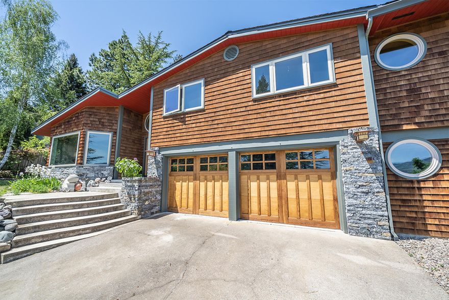 Unobstructed panoramic mountain & valley views dominate this wonderfully stylish & classically comfortable Ashland home.  Attractive stone & cedar shingled exterior.  Private oversized .39 lot has mature landscaping, perennial gardens, rock walls, large entertaining deck & lawn areas, garden & upper outdoor hideaway ringed by shade trees.  Magical!  Functional easy flow floor plan opens to spacious living room w/view  windows & dbl sided FP.  Cheerful kitchen has new appliances, matte tile counters, granite dining bar & double corner view windows.  Bright dining room with skylight, FP & slider to fabulous rear yard & dining deck.  Wood flooring throughout office area, dining room & kitchen.  All bedrooms have architectural interest & gorgeous views.  Spacious master opens to lrg view deck overlooking the gardens & valley beyond.  2nd & 3rd bedrooms are wonderful, nice use of wood, light & beautiful views.  Lower level has 244 SF office/art studio.  Ask for link to 3D walk-thru tour.