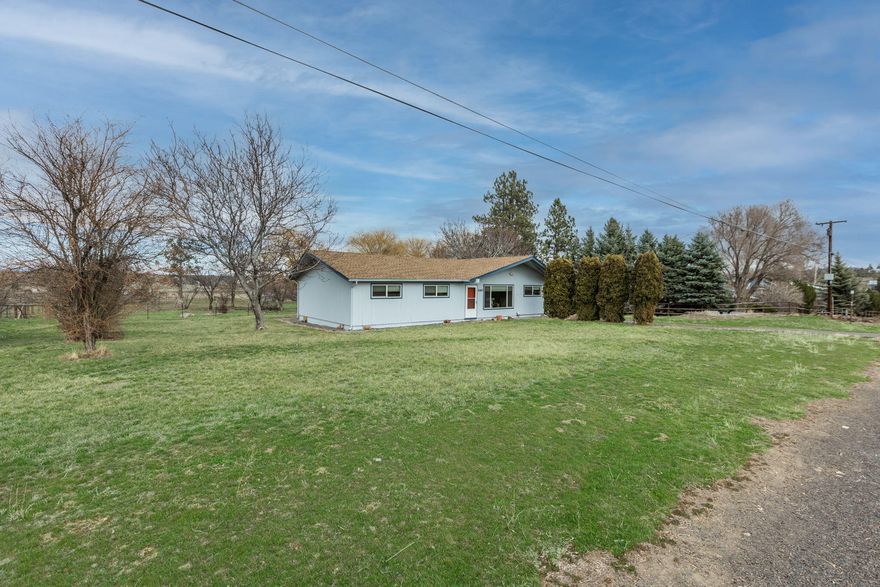 Cozy single level farm home located on the southern side of town just on the outskirts of Madras. Easy access to Hwy 97 or the Culver Hwy.  Built in 1964, this 4 bedroom, 2 bathroom home has 1352 square feet of living space.  4th Bedroom is spacious and currently being used like a family/workout room.  Kitchen was updated in recent years with lots of counter/cupboard space. A few of the spare bedrooms offer hardwood flooring.   Attached carport and built in storage shed. Recently painted on the exterior, home has also been updated through the years with newer vinyl windows.  Covered back patio off of the dining room where you can enjoy the sunsets and pasture view.  Listing offers TWO tax parcels. House lot is .90 of an acre - additional buildable 2.63 acre lot that offers flood irrigation.  Unique opportunity having a house on a larger lot as well as an additional buildable tax lot.  Call your Realtor today to schedule your personal showing.
