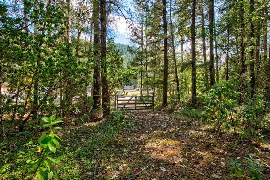 Great investment opportunity! 4 acres with 2 bedroom/1bath home.  Carport is half enclosed creating a full laundry room (needs TLC) and a separate hobby room or 3rd bedroom (est. additional 400 SF)! The home sits on 4 mostly level acres, with a separate outbuilding (shop? Office?), garden area & separate road access at side of property. Could be a great rental as tenants would like to stay, otherwise 90 days notice to vacate required if purchased. Tenants rights apply, 24 hour notice and appointment is required. Tenants will stay at showings but remove dogs when property is shown. 1 of 3 tax lots, see listing number  220125293 for package deal.  Property is being sold AS IS with seller not paying for any repairs.  Buyer to perform their own due diligence.