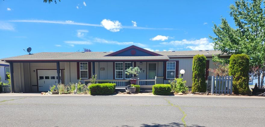 Welcome home to Suntree Village, one of Bend's finest 55+ parks. This updated, move in ready, home is light and bright, has vaulted ceilings, lots of windows, laminate floors, ceiling fans and window coverings throughout, home has a spacious floor plan, a comfortable living room, nice dining area and a kitchen with lots of cabinets and counter space and a cute kitchen nook, all appliances included, large primary suite with lg closet and barn doors leading to large suite with wainscoting, decorative vanity and mirror, lots of storage and lg stall shower, primary bedroom has good separation from the other bedroom, 2nd room is large and has a place to do crafts. Utility room is private and includes washer and dryer. Also, Heat pump, Insulated one car garage with storage area, front patio, covered back deck and grassy fenced backyard. All in walking distance to The Larkspur Community Center where you can swim and exercise. A Must See!!