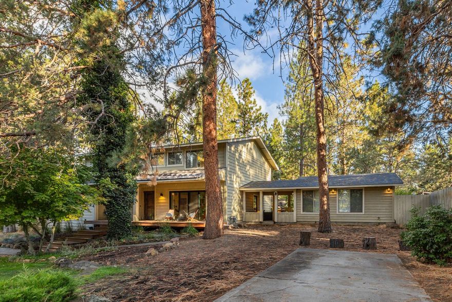 Tucked in the private and tranquil King's Forest neighborhood in Southeast Bend, this home offers an exceptional mix of charm, space, and functionality. Here you will find a lovingly updated main home featuring mid-century touches along with an additional 400 SF mother-in-law space accessible through a covered breezeway. The main floor offers distinct spaces for living, dining, and gathering, which connect to the outdoors beautifully via front and back decks for all-season living. Upstairs, three spacious and light-filled bedrooms share a full bath, and just down the hall lies the primary suite with newly refreshed tile and plenty of storage for all. Outside, old growth trees abound throughout the half-acre lot, along with a natural rock outcropping. A large expanse of grass in front of the home, full RV parking, and a fenced backyard with turf make this an ideal place to call home. Southeast Bend neighborhoods seamlessly blend outdoor living with urban convenience.