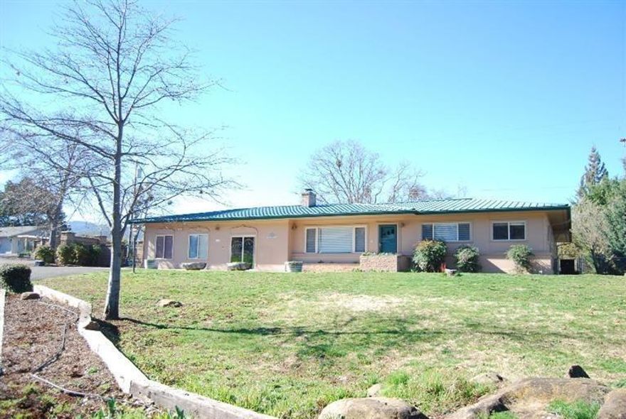 View property in a close-in location w/a HUGE shop/garage and a 4 Bedroom house w/TONS of updates. Gated entry to rear yard & LG paved parking & shop. Serene rural neighborhood. Home features a living room w/fireplace AND a family room w/3 large skylights ALL w/new hardwood flooring. 3 Bedrooms on one wing w/newly tiled guest bath. Separate hall to dbl doored master w/hardwood floors, sliders to rear deck, his & her closets, master bath w/jetted tub, lg tile shower, views. Kitchen w/newer granite counters and tile backsplash, newer appliances & breakfast bar. 2 steps down to a LARGE dining area w/built-in cabinets & shelves. Bonus large multi-purpose rm for home based business/hobbies/pets/etc. Utility/mudroom w/sink & storage. AWESOME 2040 sq. ft. deck w/iron railing to enjoy the views of the Griffin Creek area & southern mtn. 1525 Square foot shop/garage + carport + tons of paved area for parking. Vinyl windows, newer paint & carpet. So many updates, you must tour