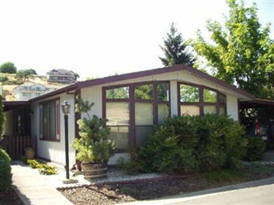 Great 2 bdrm, 2 bath home in Rogue Valley South 55+ Park. This home is located on a cul-de-sac and has a beautiful fenced yard with wonderful flowers, trees, and patio. The living room features beautiful cathedral windows, newer carpet, laminate floor in the kitchen. There are 2 large skylights, a snack bar and ref/washer/dryer are included in sale. The spacious M/bath has a garden tub and stall shower with a skylight. The M/bdrm has newer blinds and a large closet. This is a very nice home located in a top park.