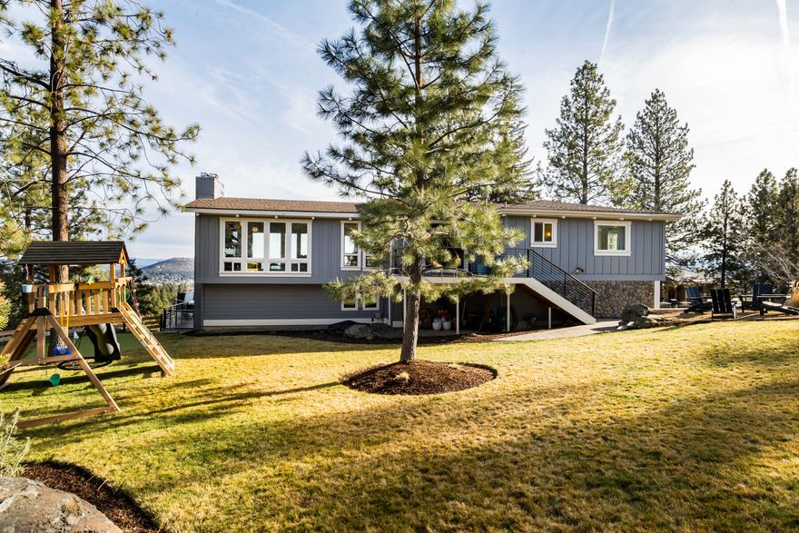 Located in the desirable neighborhood of West Hills sits this stunningly renovated home with unobstructed easterly and city views!  Over 2000 square feet of new trex decking, a newly landscaped yard, and a personal two-hole putting green make this the perfect place to entertain and enjoy Bend's beautiful outdoors. The open floorplan upstairs allows for an abundance of natural light with floor-to-ceiling windows in the kitchen, dining, and living areas.  A newly updated Primary Bedroom and Bath playfully combines earthy tones and modern fixtures...a beautiful space to relax and unwind. Downstairs there is an additional family room, fireplace, 2 additional bedrooms, one full bath, and a mud room/laundry room. The spacious 2-car garage has plenty of space for all your Central Oregon Toys.  You will not want to miss this rare opportunity to own a completely renovated West Hills home with an abundance of outdoor space and spectacular views!