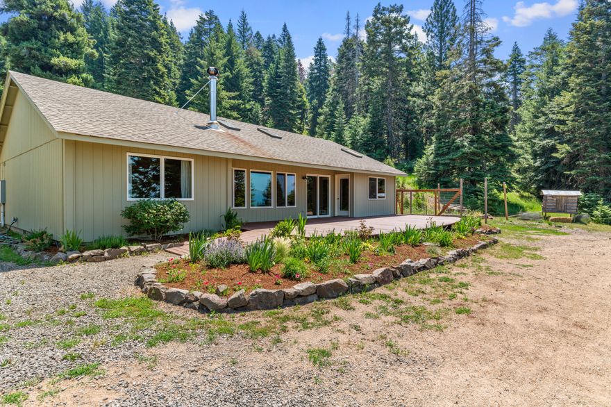 This EFU property has gorgeous panoramic views of the Siskiyou Mountains and Mt. Ashland. Good well, creek, seasonal springs, including a seasonal pond. Enjoy serenity in this peaceful and private 3 BR, 2 BA, 1560 sq ft mountain home with an open floor plan, vaulted ceilings & skylights. Floors, dishwasher, range, water heater and more newly updated. This house has a separate 456 sq ft studio above detached garage with 1/2 bath, kitchen sink, and plumbing for a shower. This home creates separation between the master bedroom and guest rooms. The main home also features a large laundry room, ceiling fan, and a BlazeKing wood-burning stove that keeps the house extra toasty. Plenty of outdoor living with a vast deck, patios, dog run, gardening beds, and chicken coop. Marketable timber & underground utilities. Bordered by BLM land on two sides of the property.