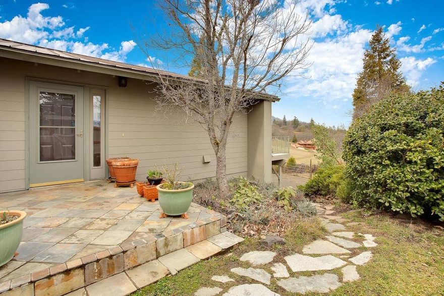 Sweet Close-in Talent Country Home. This well-cared for property is bathed in abundant natural light with soaring vaulted ceilings in the main living area, big picture windows and deck to enjoy outstanding views to the Table Rocks, and a spacious, well-appointed tile kitchen with oak cabinetry. The vaulted master bedroom and near-by guest bedroom have beautiful views to Wagner Butte, plus there's a large downstairs room that can easily be used as another bedroom, den or office area. There's an additional 500 square foot finished bonus room with separate entry that would make a great art studio or workshop and separate entrance, and an oversized single garage with additional shop space, too. The lovely grounds include big cedars, fruit trees, nice pathways and mature plantings. Lots of upgrades new interior/exterior paint, new HVAC and fresh carpets, too. This is a lovely spot has easy access to all the amenities of the Rogue Valley. Wonderful!