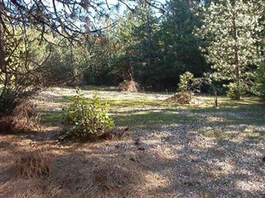 If you are someone who appreciates natures beauty and privacy, this land is a must see for you. 13.24 beautifully wooded acres including Evergreen trees. This property is next to BLM land. It is partially fenced with a gate and has paved road access. Owner states that this is a previously approved home site. Buyer should investigate. There are two wells. Financing available to qualified buyer, minimum $50,000 down.