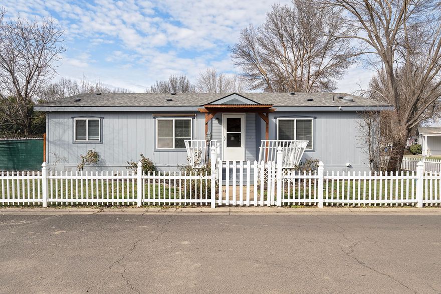 Welcome to unit 63, a hidden gem in the heart of Butte Crest Park, Eagle Point, a premier manufactured home community. This charming 3 bedroom, 2 baths offers a great floor plan and modern look. The home boasts new Cortex laminate flooring throughout, The bathrooms have been remodeled with a warm, contemporary aesthetic and the kitchen shines with stainless steel appliances. Sola-tube skylights in the kitchen and bathrooms invite natural light, creating a bright and inviting atmosphere. Situated on a generous corner lot, this home offers a peaceful retreat just steps away from the community clubhouse. Whether you are hosting a summer barbeque  or enjoying a quiet evening under the stars, the new paver patio and privacy fencing make it all possible. Call today for a showing!